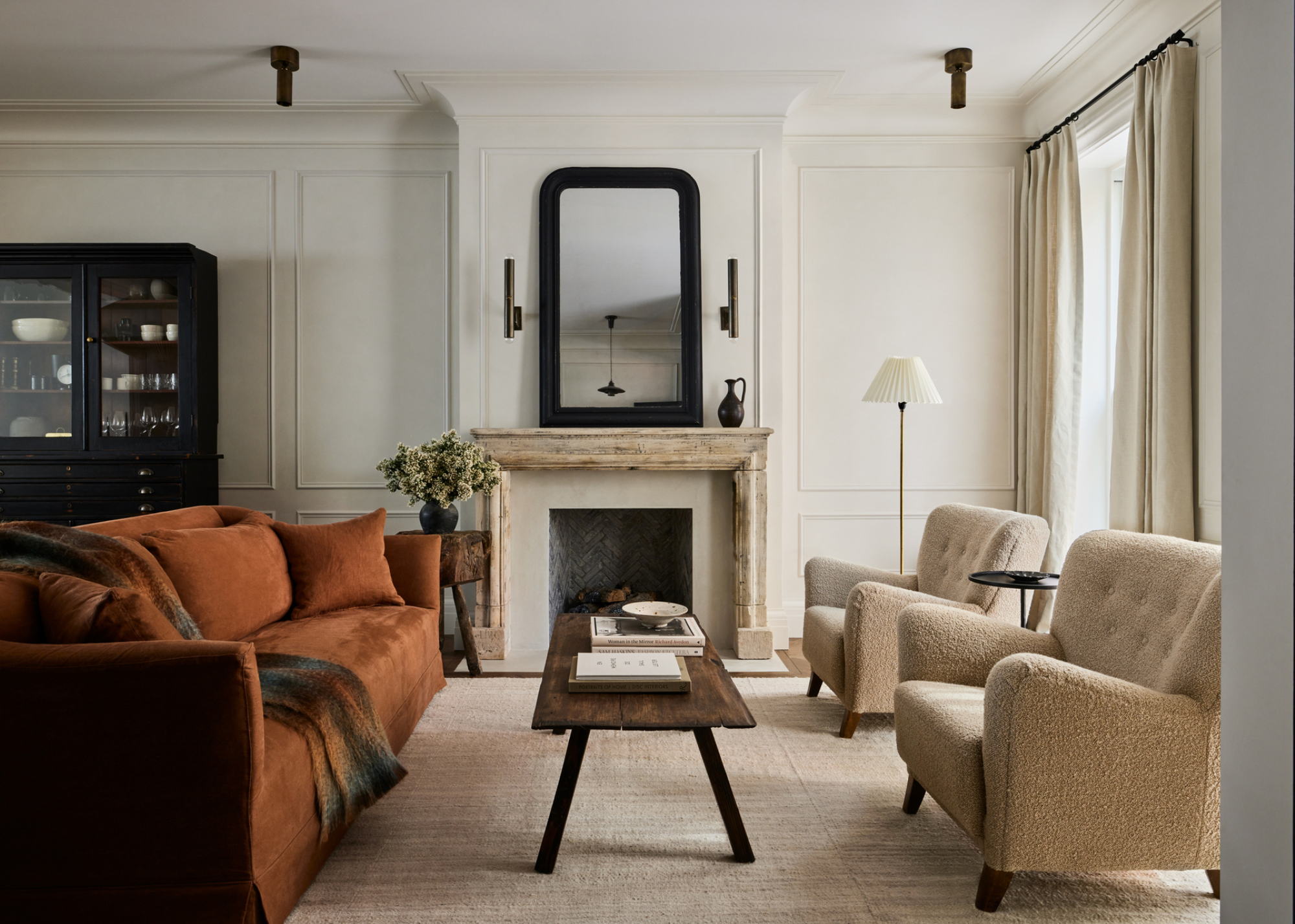 A living room with a mirror focal point and two sofas on each side