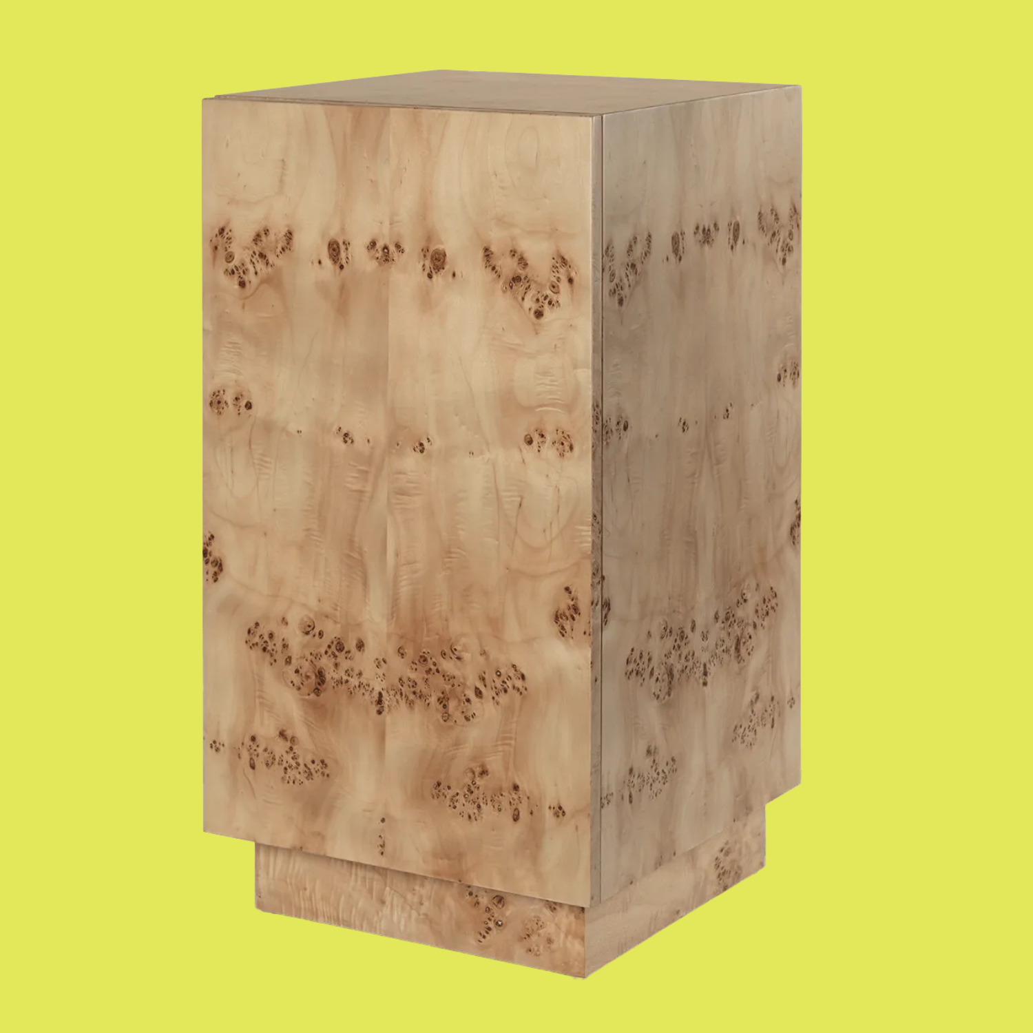 A burl wood side table pedestal from against a neon yellow background
