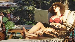 A woman in sunglasses and a bikini with a laptop