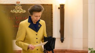 Princess Anne, Princess Royal prepares to sign the guest book after the Service of Remembrance