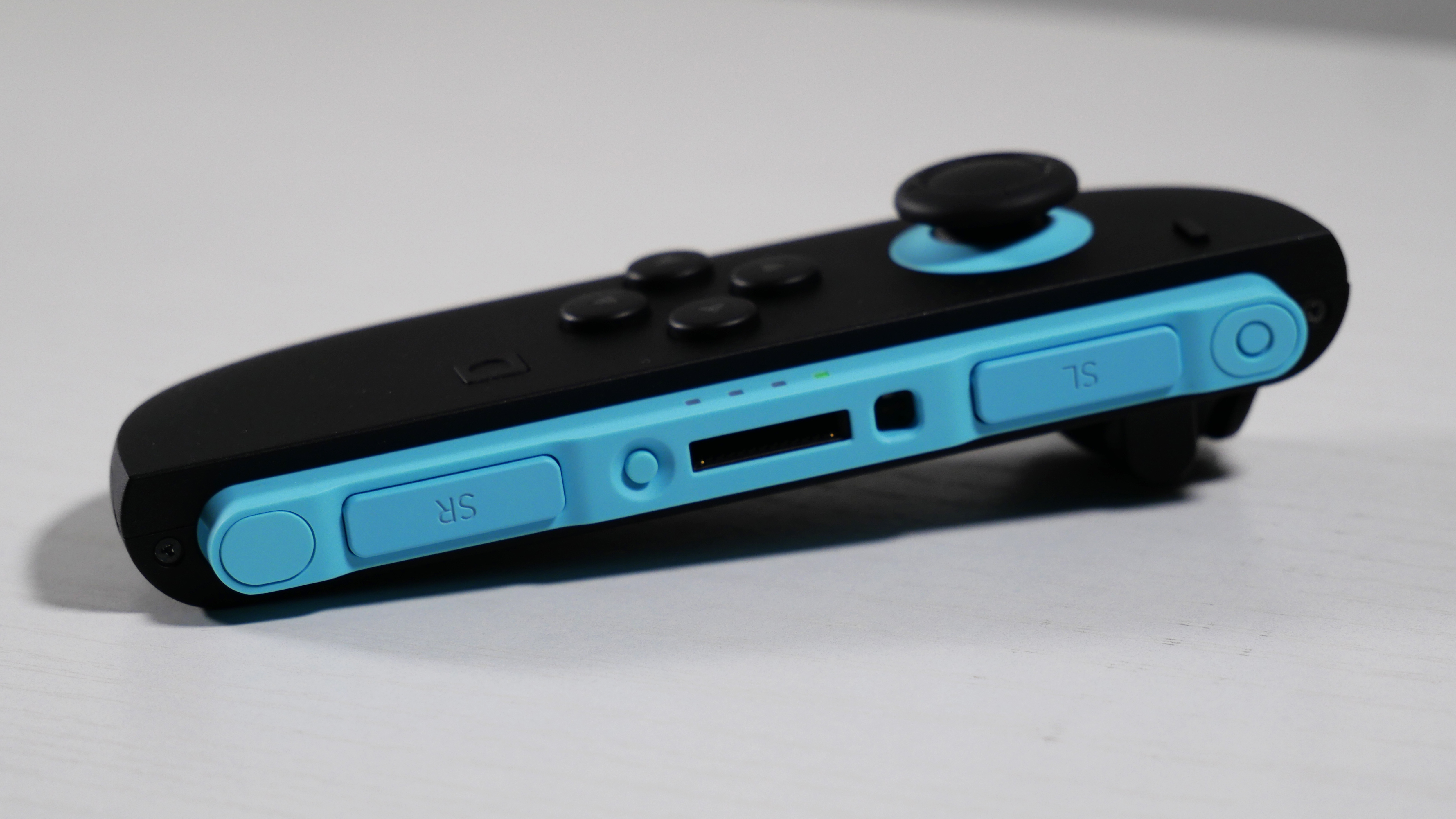 Nintendo Switch 2's Blue Joy-Con 2 lying detached on a white desk.