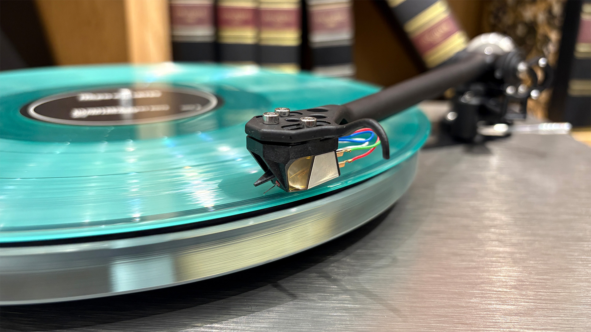 Rega Planar 6 RS Edition turntable playing blue vinyl record close up on headshell