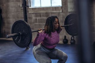 Photo of someone weight lifting in a gym