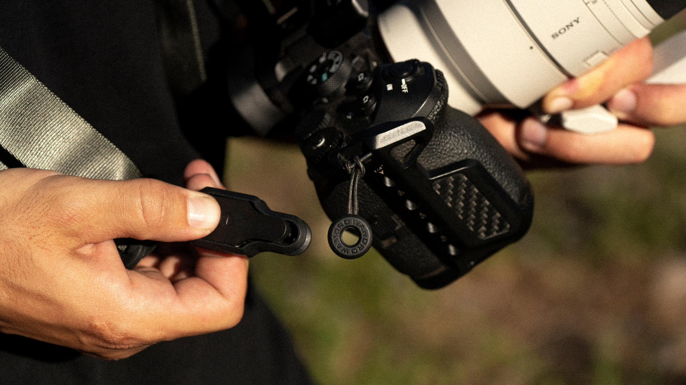 The Wandrd Magnetic Camera strap being used by a photographer