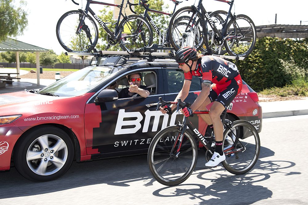 Daniel Oss (BMC) drops back to the team car for a gel