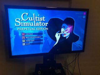 A photo of a PC monitor with the Cultist Simulator game displayed on screen