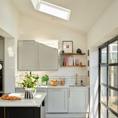 large neutral kitchen with kitchen island and skylight and large patio doors