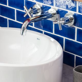 A bathroom sink with the tap running