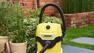 A yellow outdoor hoover on a patio