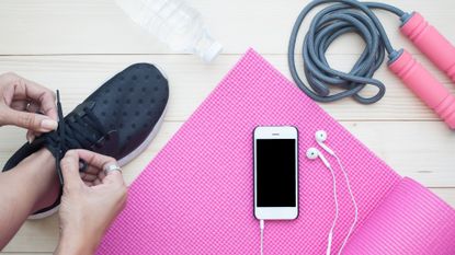 Exercise accessories including a water bottle, earphones and workout shoes