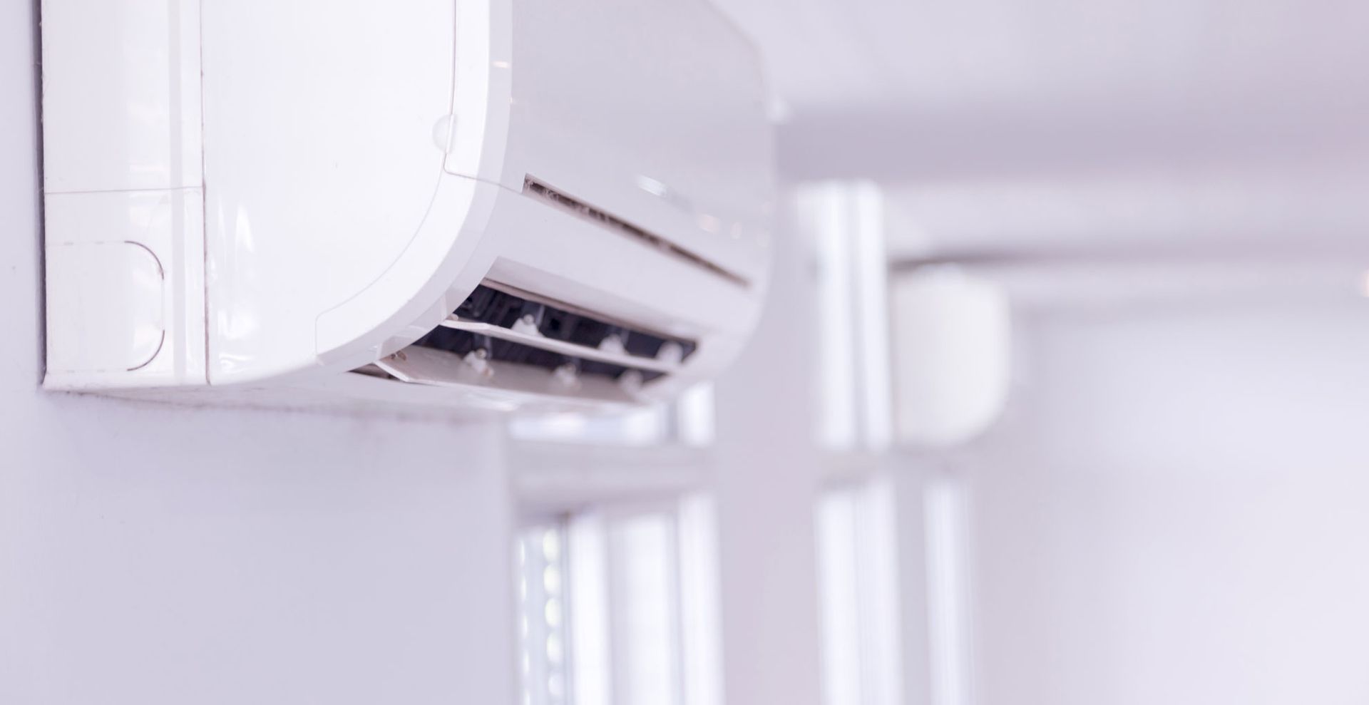 air conditioning unit in a white living room to show how cleaning filters is key for how to get rid of dust