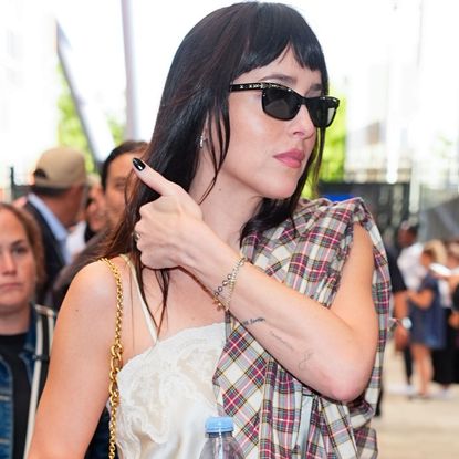 Dakota Johnson styled a flannel outfit for fall with jeans and a lace-trimmed camisole at the 2026 US Open