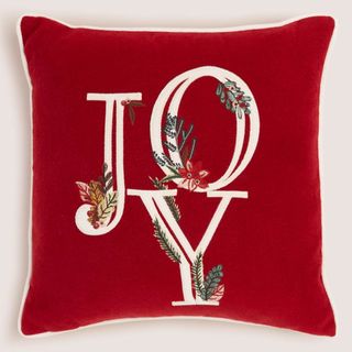 Red Christmas cushion with "JOY" embroidered in white