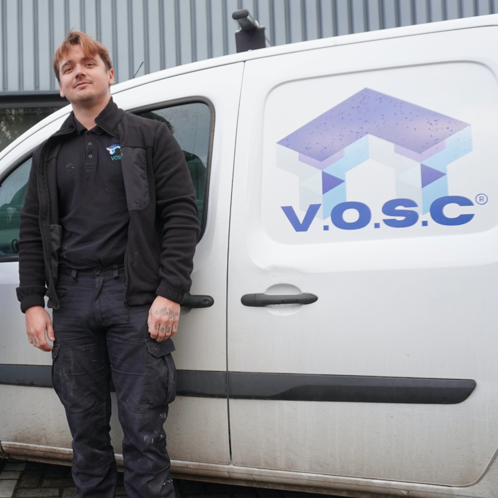 Vic Slovak standing by a company branded van