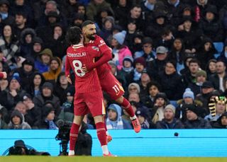 Dominik Szoboszlai celebrates with Mo Salah after scoring Liverpool's second goal in the Premier League match against Manchester City at the Etihad Stadium on 23 February, 2025