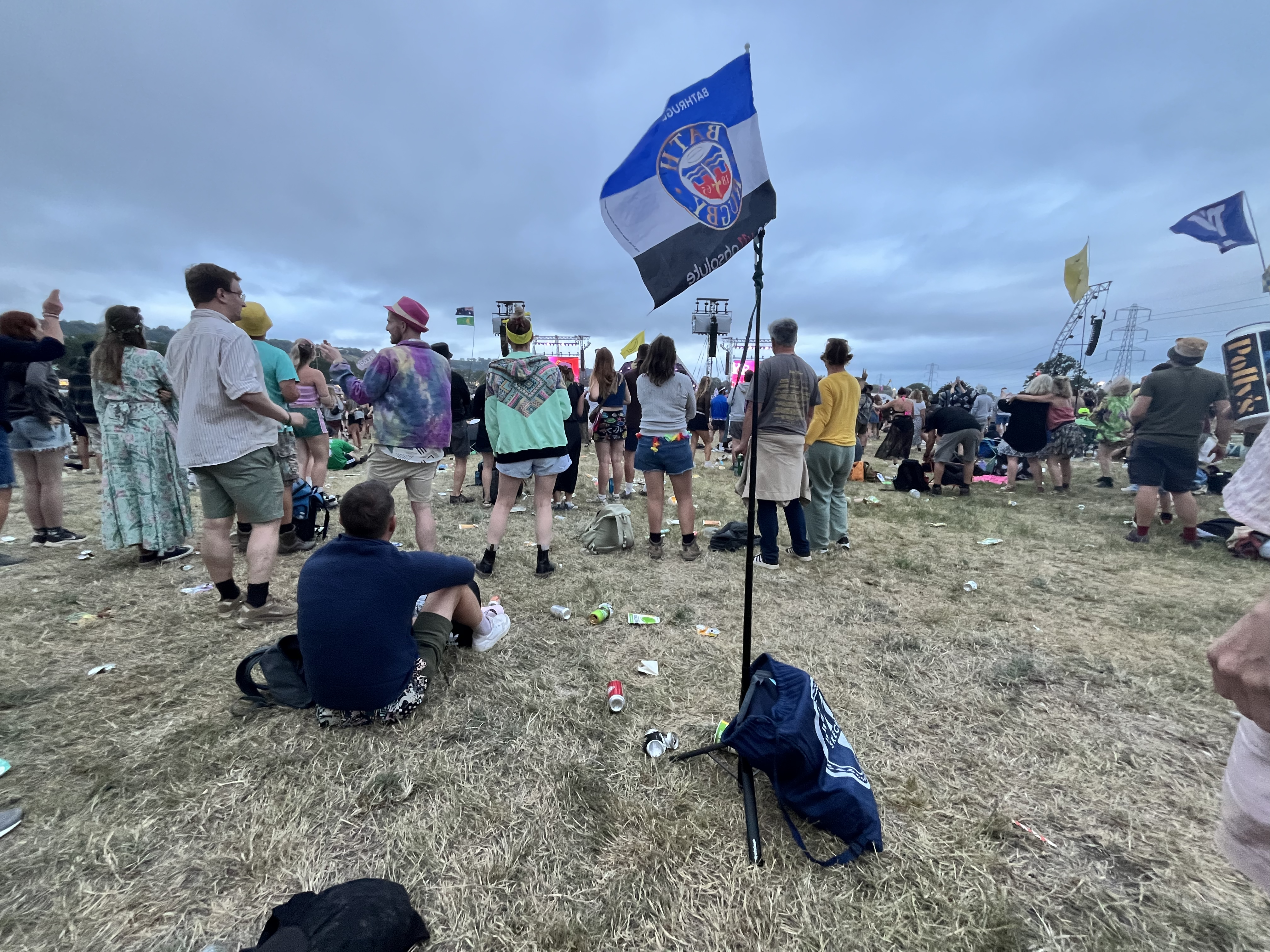 KraftGeek JustTap Magnetic Phone Tripod being used as a flagpole with legs extended at Glastonbury festival 2025