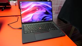 Images of the Lenovo ThinkPad X1 Carbon Gen 13 Aura Edition on a red table at IFA 2024