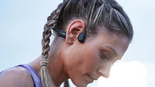 Woman wearing Shokz OpenRun Pro running headphones