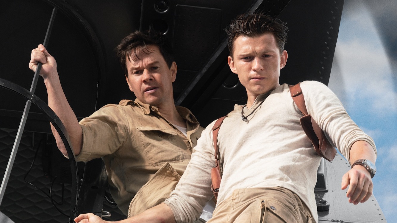 Mark Wahlberg and Tom Holland in Uncharted looking down at something from a great height