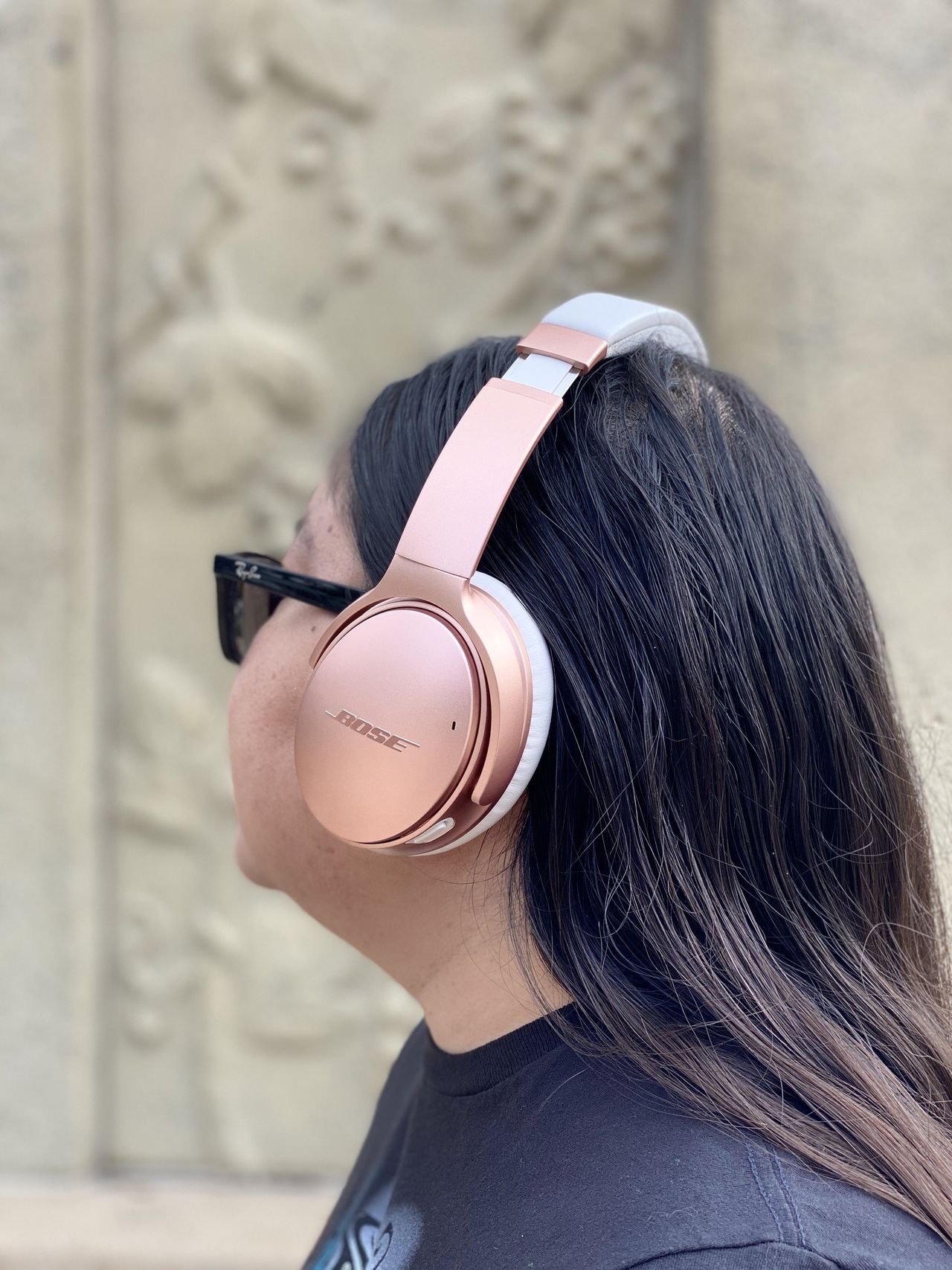 Christine wears her Rose Gold Bose QuietComfort 35 II headphones