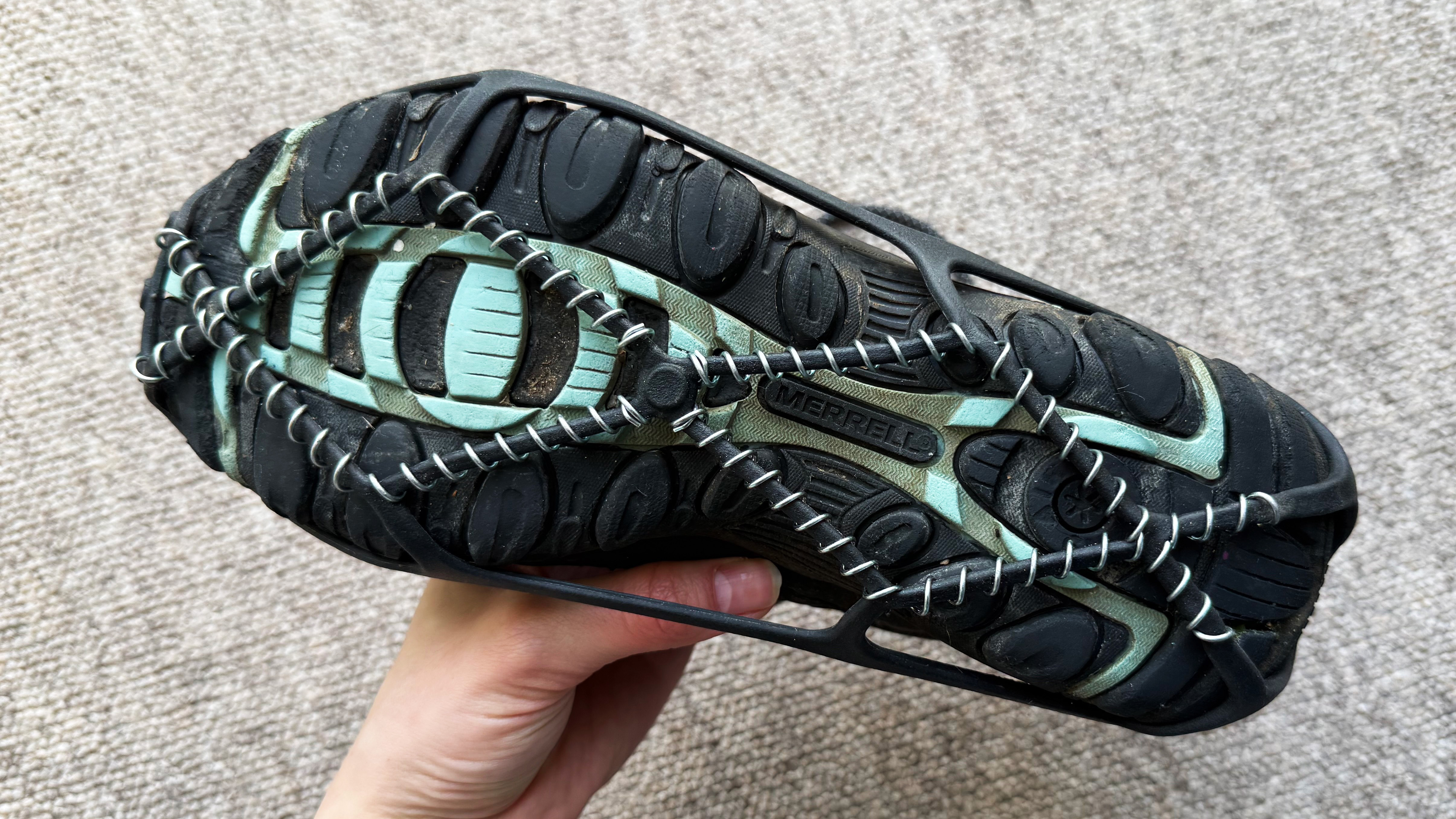 the merrell sport 3 hiking boots with yaktrax photographed inside, the sole, side, and top