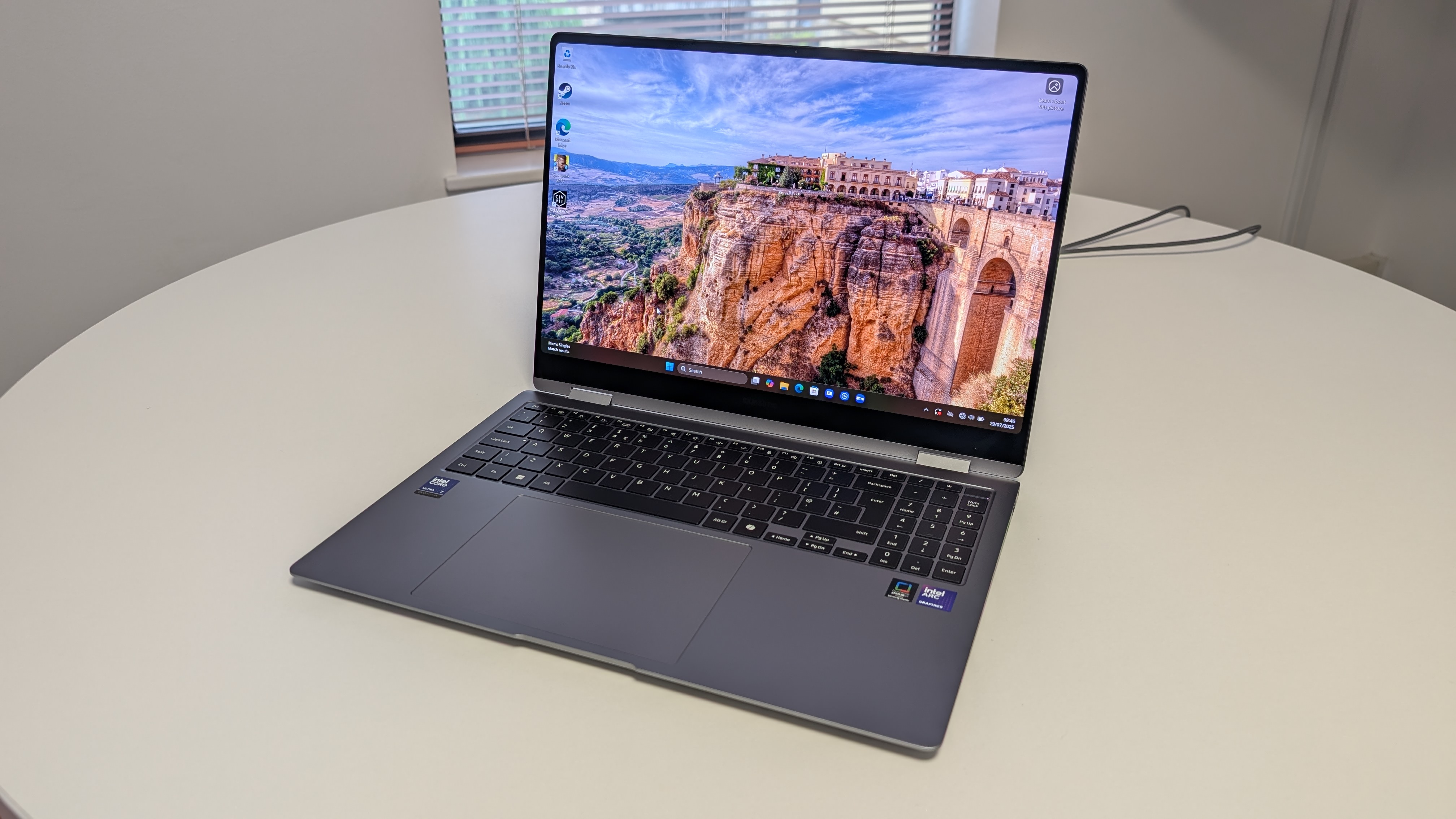 The Samsung Galaxy Book5 Pro 360 photographed on a white desk.