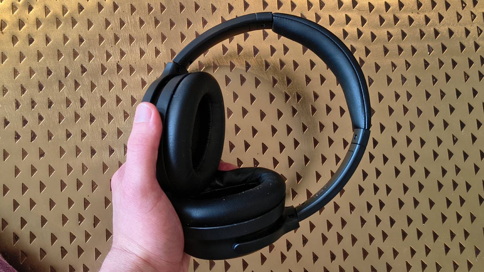 The Earfun Tune Pro atop a bronze table.