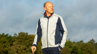 A golfer wears the Galvin Green Lyndon Windproof Jacket