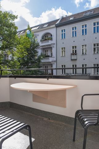 A balcony with a flexible table