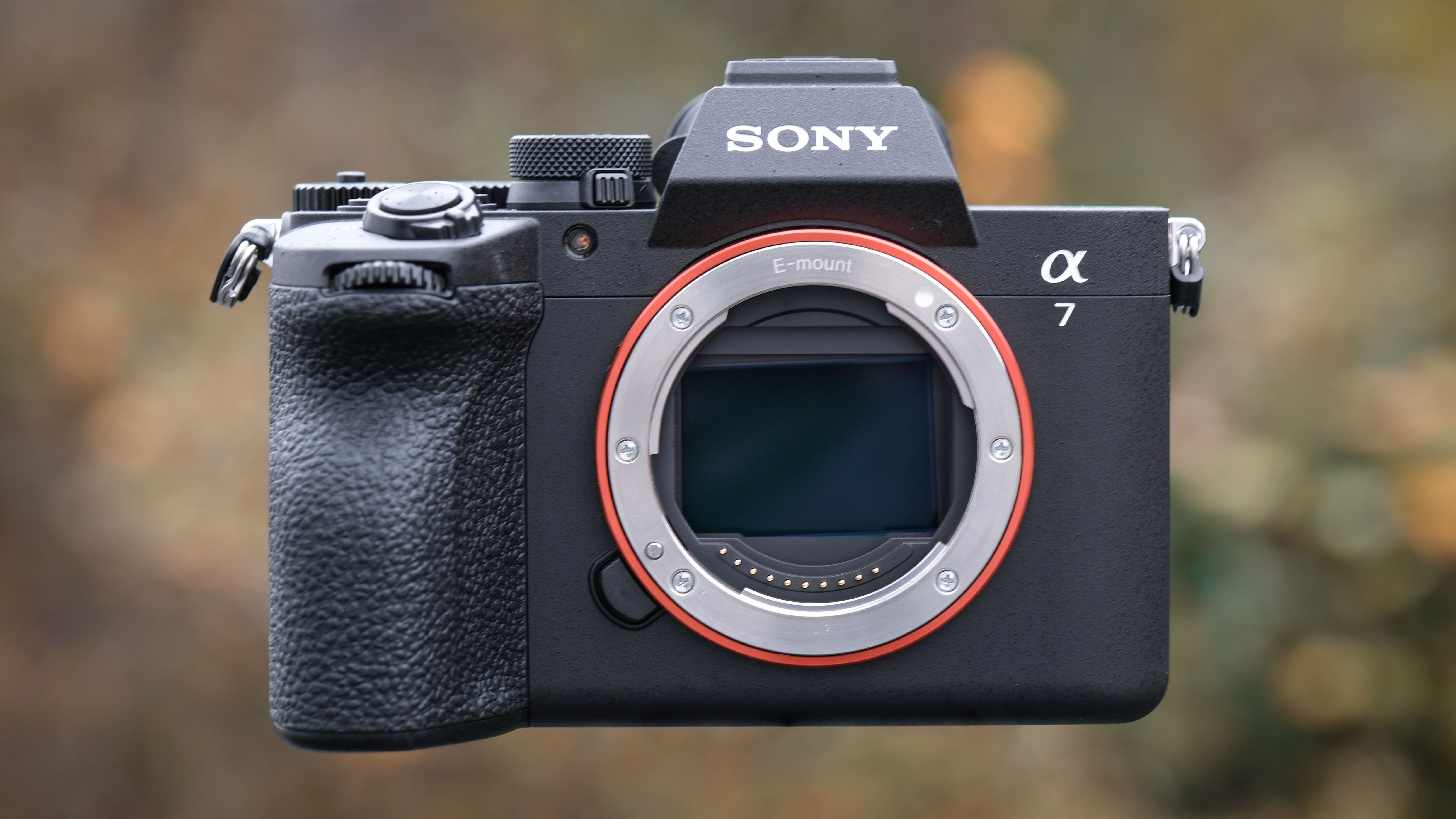 Sony A7 V against a green outdoor background