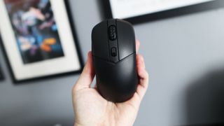 MSI Versa 300 Wireless 8K on a desk and held in a hand.