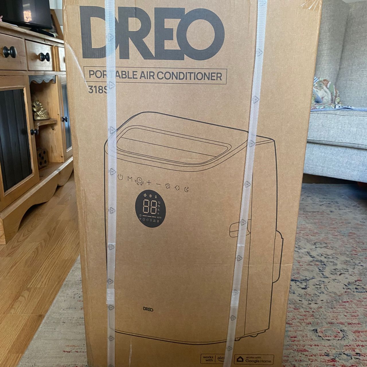 Outer packing of the Dreo 318s portable air conditioner in a living room
