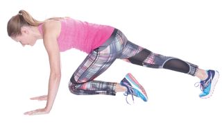 Woman doing mountain climbers as part of the 30-day HIIT challenge