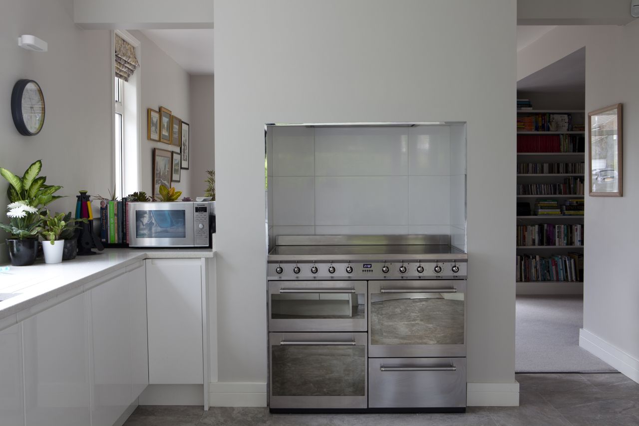A sleek range sits in the former chimney breast.