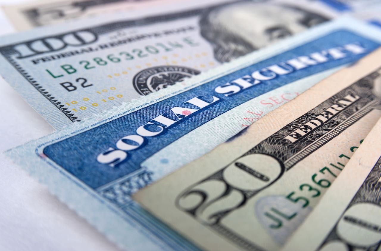 Social security card and American money dollar bills close up concept