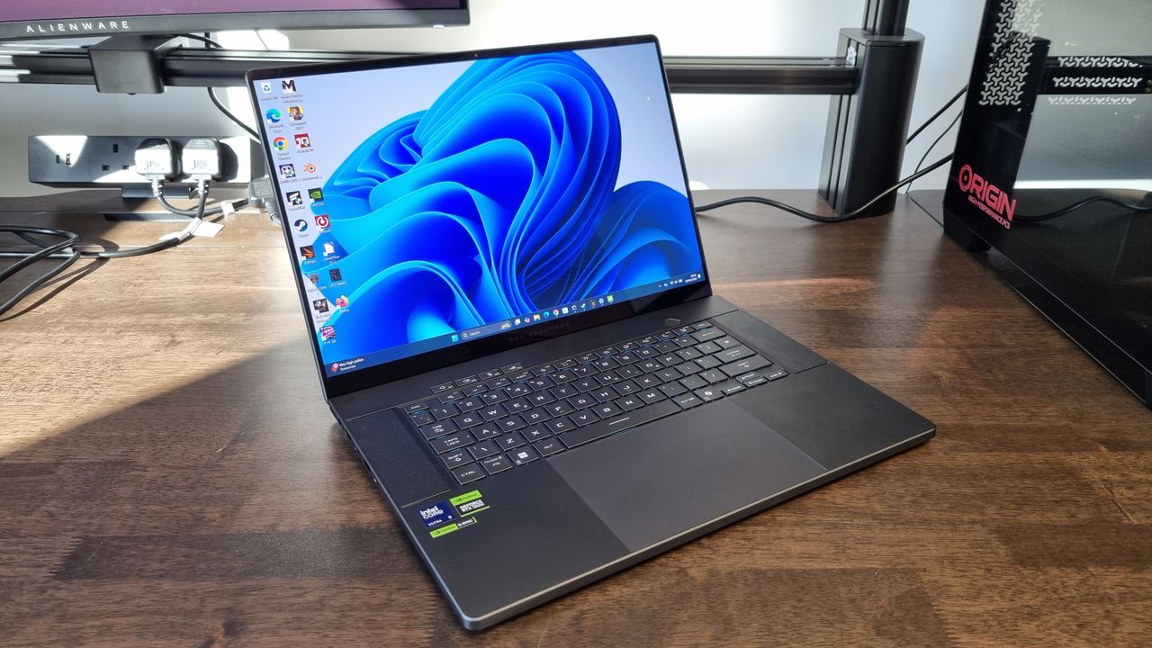 The Asus ROG Zephyrus G16 2025 gaming laptop on a wooden desk with the desktop on display