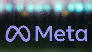 The Meta logo (a stylized 'M' next to the word 'Meta) written in blue on a frosted glass window, with blue lights visible behind the glass.