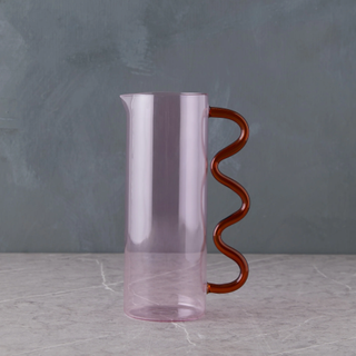 red and pink pitcher with wavy handle