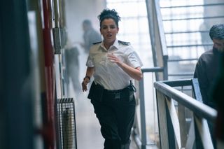 Rose (Jamie-Lee O'Donnell) is on the walkway of one of the C Wing's upper floors, and she is sprinting towards the camera