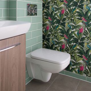 bathroom with banana leaf wallpaper on walls
