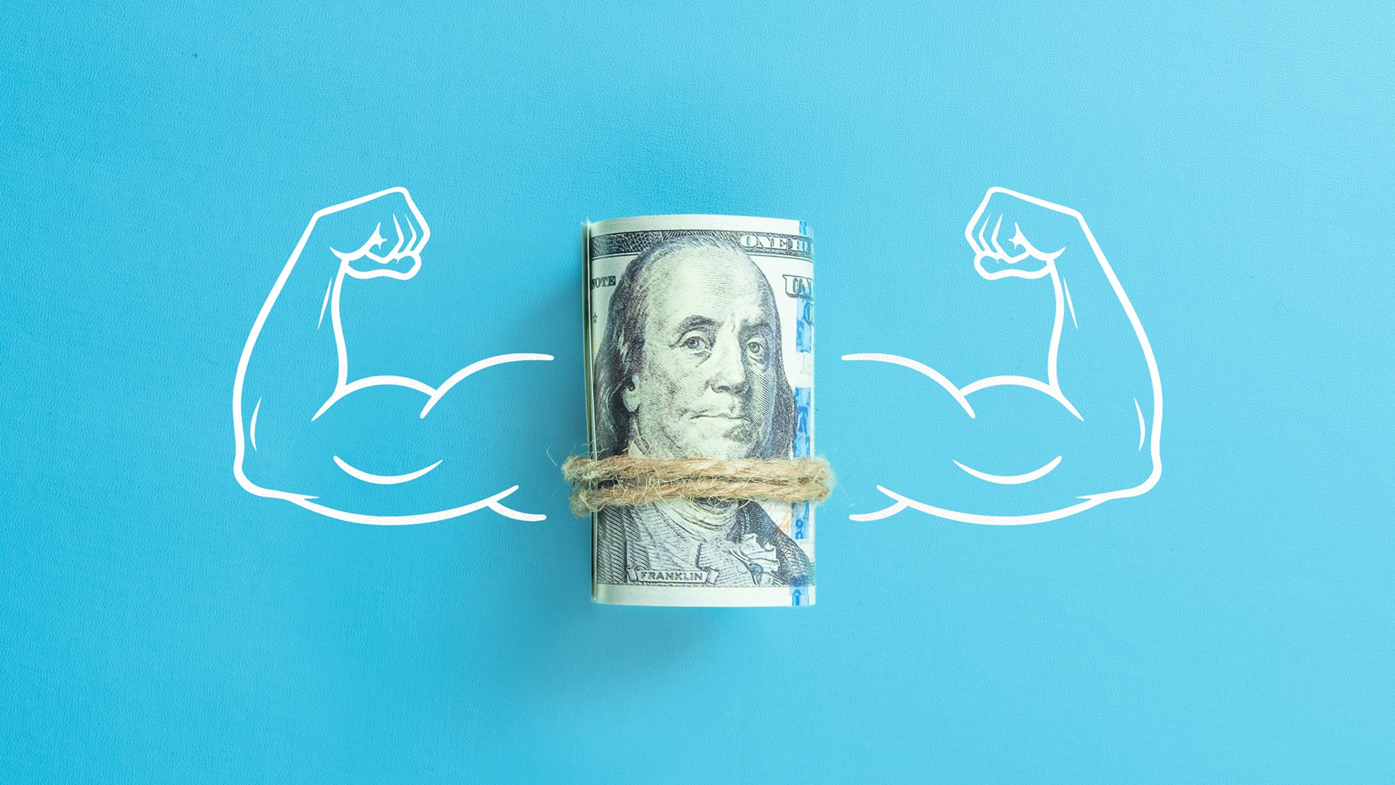 Flexed muscular arms on either side of a roll of cash.
