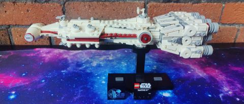 Lego Tantive IV on a starry mat against a brick background