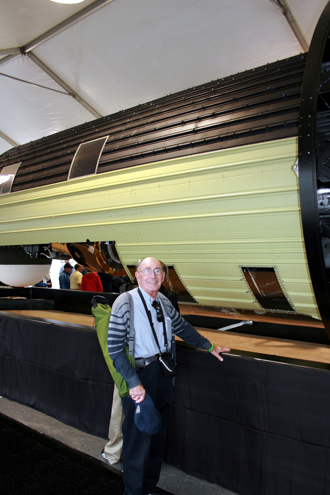 Phil Pressel, designer of the KH-9 HEXAGON&#039;s &#039;optical bar&#039; panoramic camera system, poses in front of the massive 60-foot long spy satellite at the Smithsonian National Air &amp; Space Museum&#039;s Udvar-Hazy Center on Sept. 17, 2011. The National Reconnaissance 