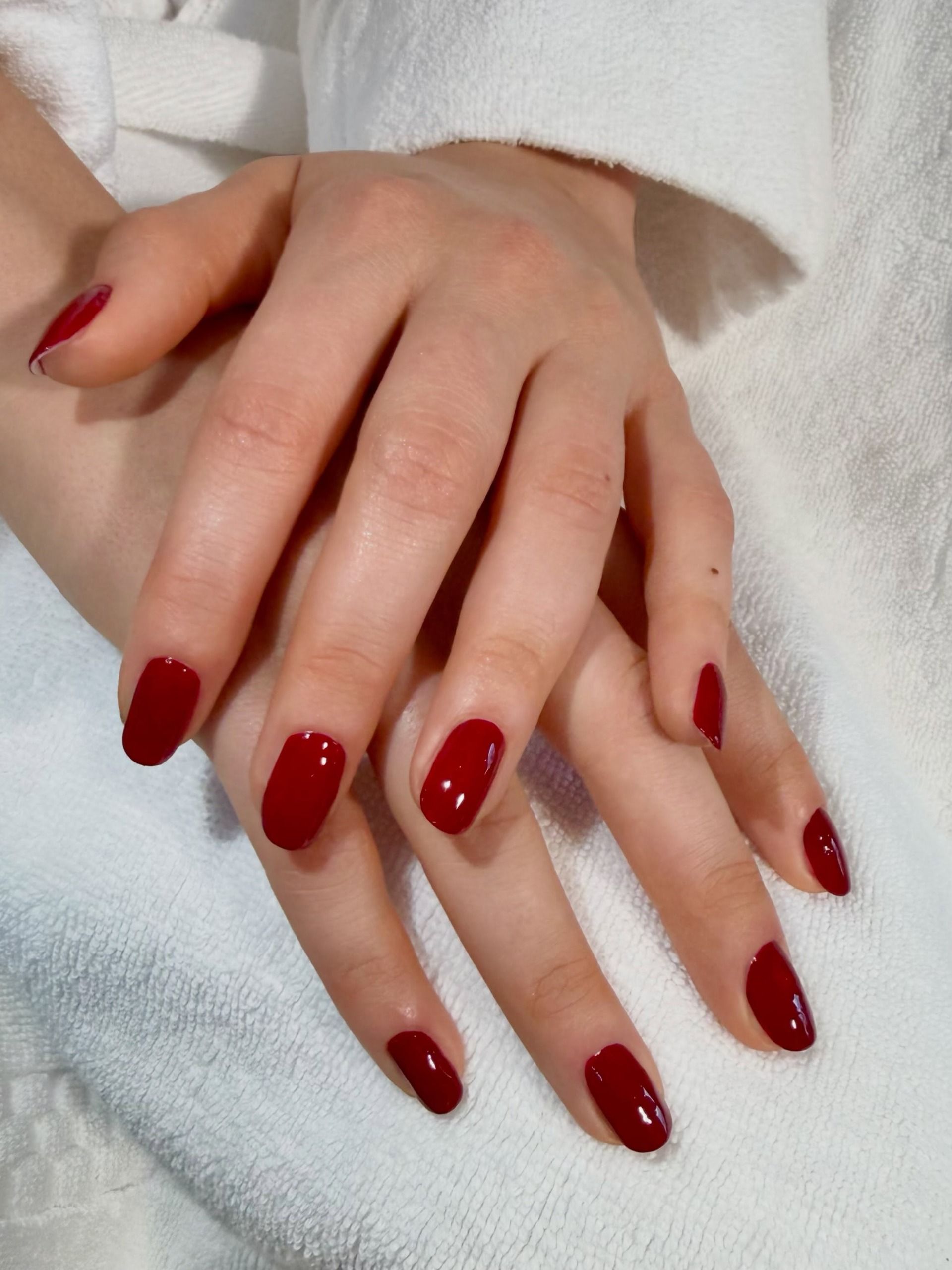 bright raspberry red manicure very glossy oval shaped nails