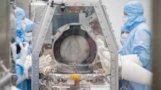 NASA scientists opening the OSIRIS-REx sample lid after the capsul's return to Earth.