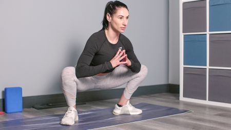 Writer Sam performing wide variation of yogi squat