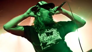 Tomas Lindberg fronting At The Gates onstage in 2014