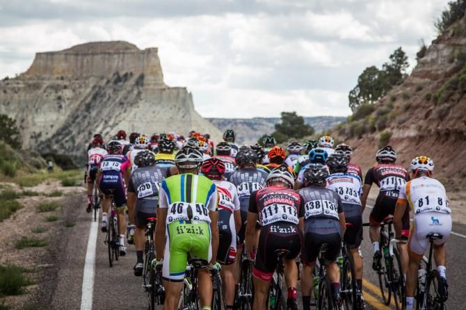 The peloton heads towards more of todays red rock canyons