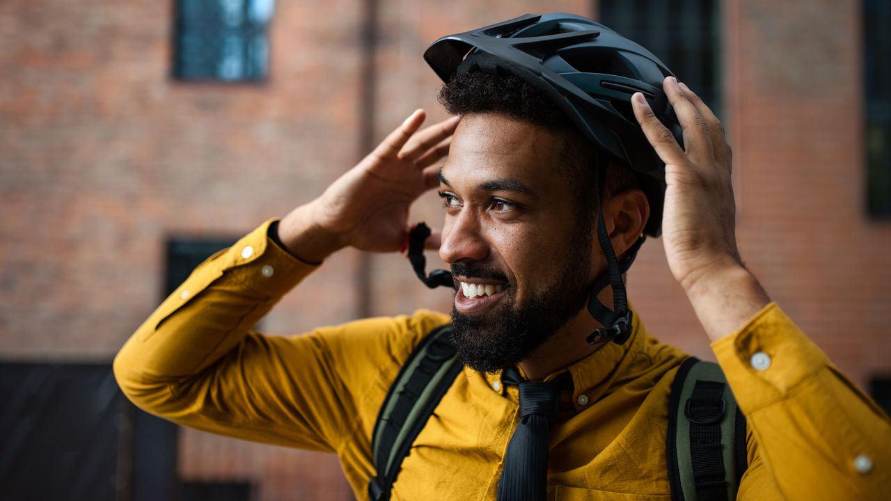 Man putting on a bike helmet