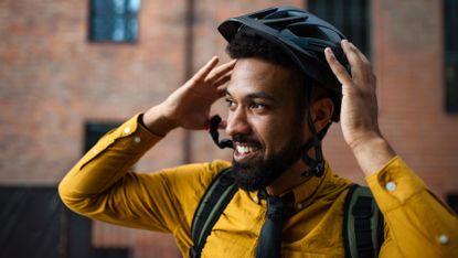 Man putting on a bike helmet